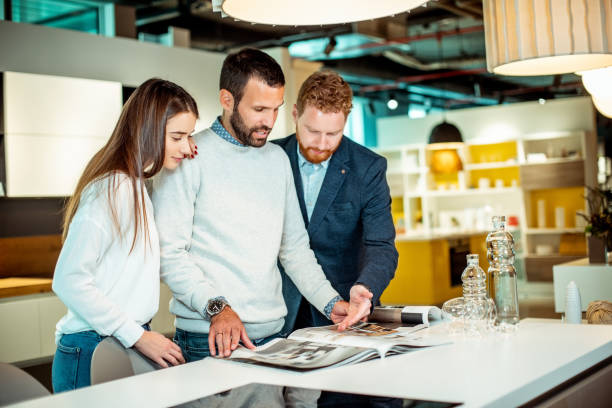Young couple talking with a sales rep in a general home improvement store