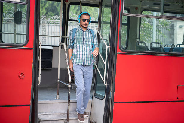 istock Young Man with Headphones is Exiting the Bus 1192445372