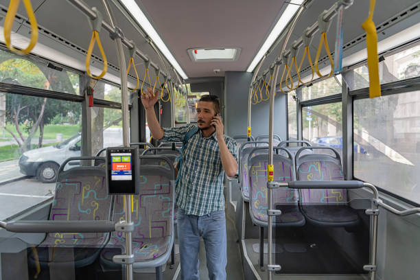 istock Casually Dressed Man in Public Transport is Communicating with the Smartphone 1192445490