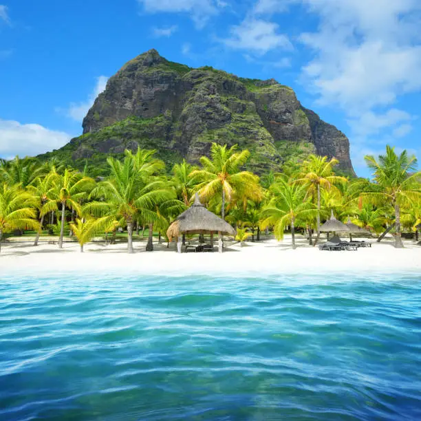 Beautiful sandy beach with Le Morne Brabant mountain on the south of Mauritius island. Tropical landscape.