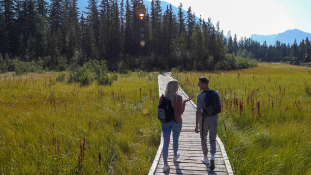 istock Young couple walks down boardwalk in the morning 1192448336