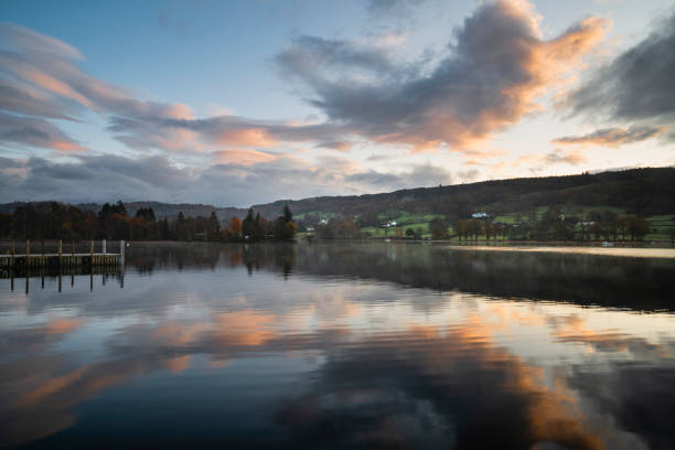 istock Stuning Autumn Fall sunrise landscape over Coniston Water with mist and wispy clouds 1192449655