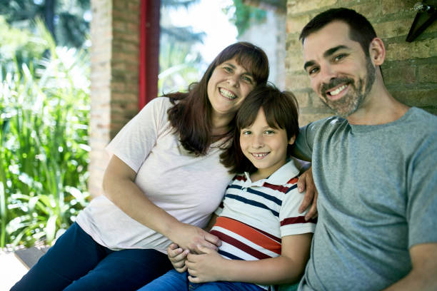 istock Portrait of Affectionate Parents and Young Son in Backyard 1192450736