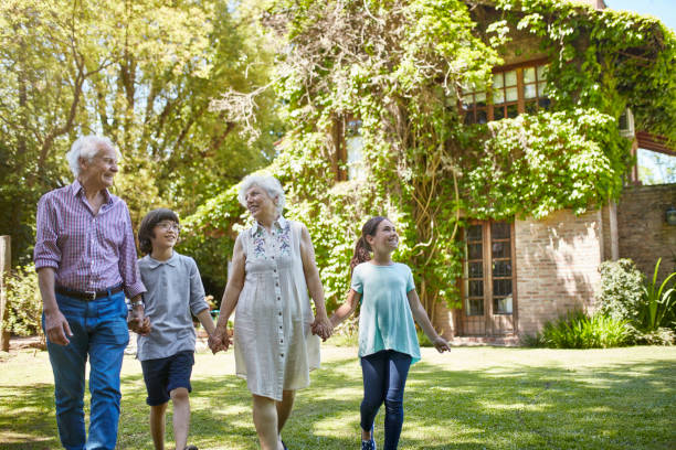 istock Smiling Grandparents Holding Hands with Young Grandchildren 1192450737