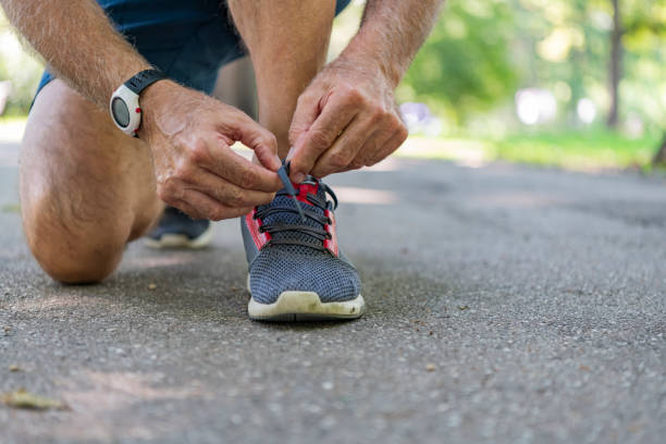 istock Senior Athlete Tying Sneaker Shoe 1192451863