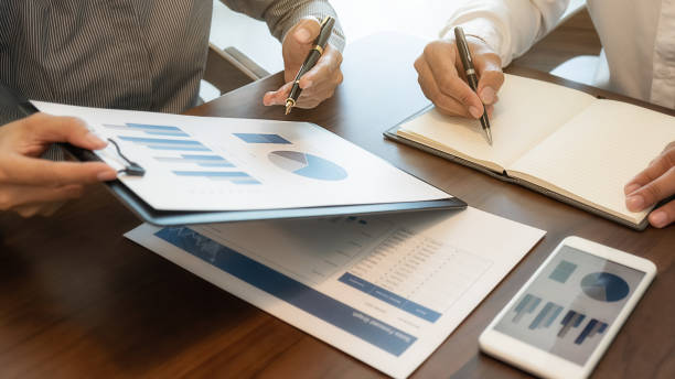 istock Business team brainstorming and discussing with financial data and report graph. Teamwork meeting working concept. 1192451935