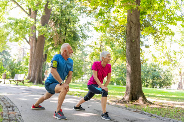 istock Mature Couple is Doing Warm-up Exercise in Public Park 1192451964