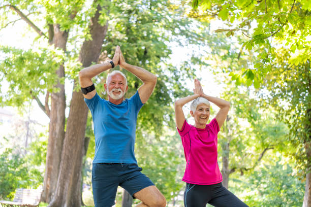 istock Active Senior Couple is Stretching Outdoors in Nature 1192452065