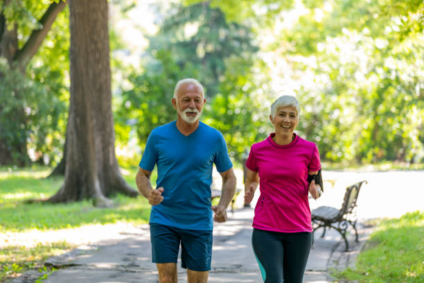istock Mature Couple is Running in Public Park 1192452147