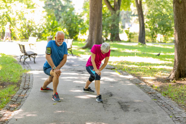 istock Mature Couple is Doing Warm-up Exercise in Public Park 1192452336