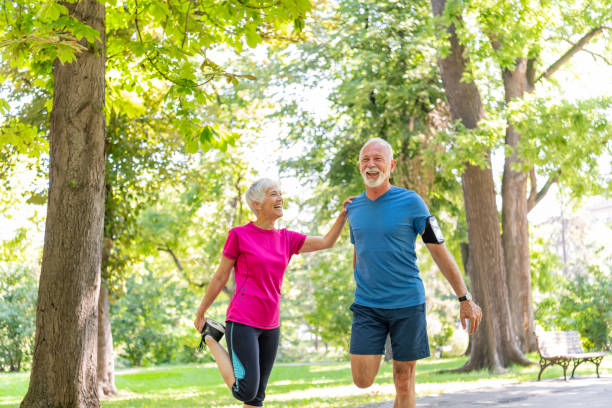 istock Active Senior Couple is Stretching Outdoors in Nature 1192453034