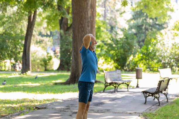 istock Mature Man is Doing Warm Up Exercise in the Nature 1192453048