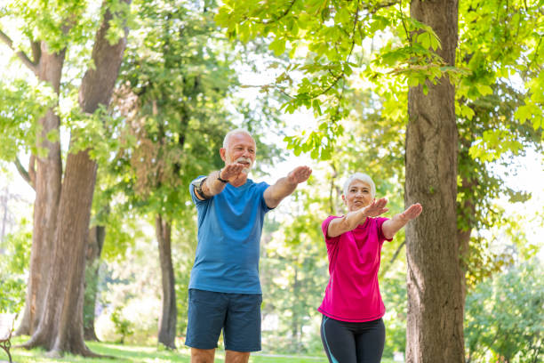 istock Active Senior Couple is Stretching Outdoors in Nature 1192453242