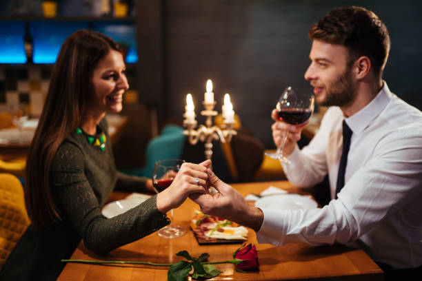istock Couple holding hands during romantic dinner in a restaurant 1192453312
