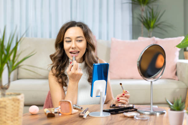 istock Young attractive woman doing live webcast at home 1192454081