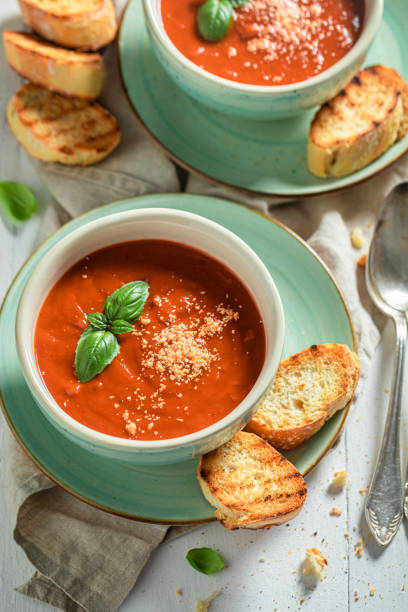 istock Delicious and creamy tomato soup with basil and toasts 1192454143