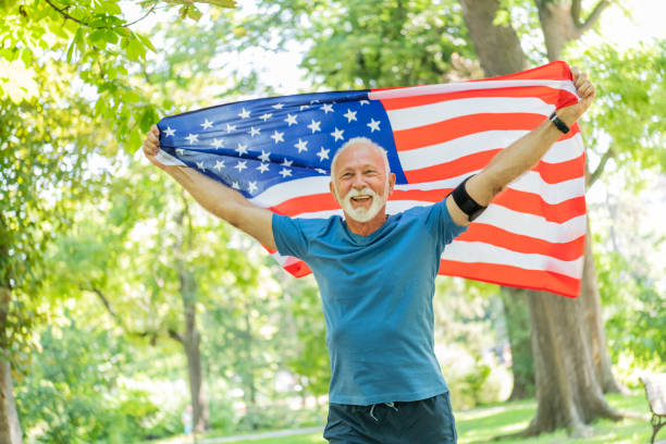 istock Senior Man with American Flag in Public Park 1192454347