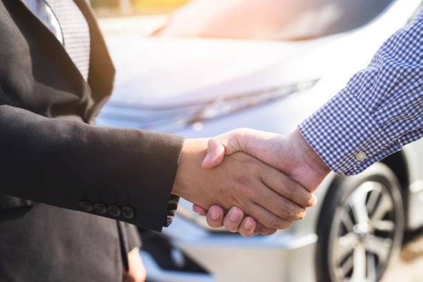 image of men handshake with new car. stock photo