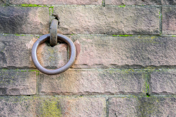 istock iron ring in a wall of reddish sandstone, background concept for strength, stability or remaining with copy space 1192459657