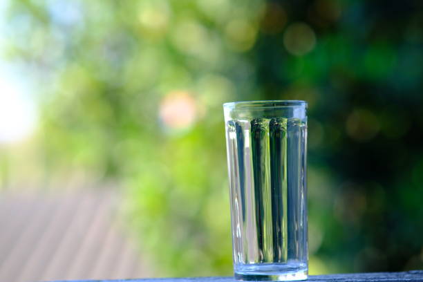 istock Water in glass on counter background 1192460807