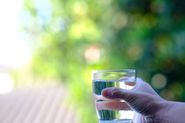 istock Water in glass on counter background 1192460993
