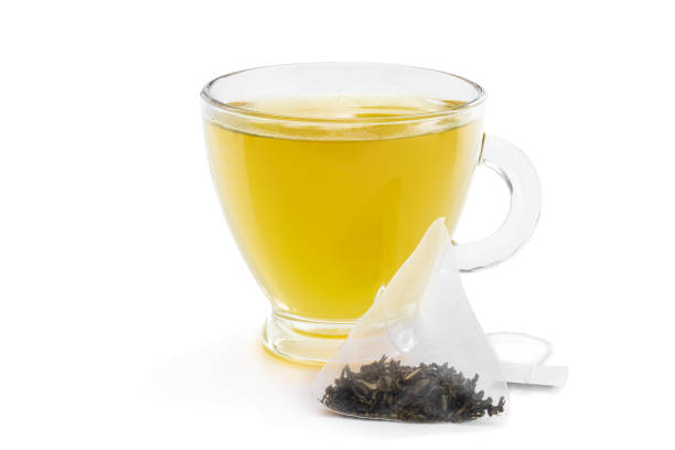 istock Cup of green tea with jasmine and pyramid tea bag isolated on white 1192462065