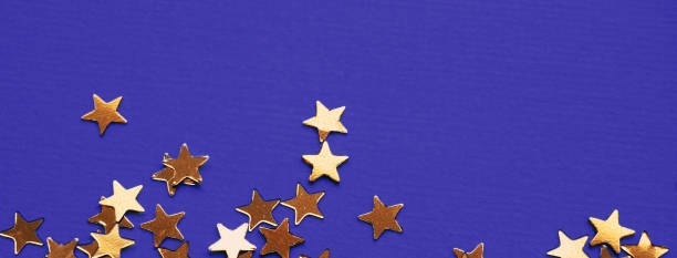istock Golden stars glitter on violet background 1192464910