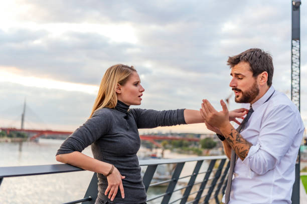 istock Handsome Man is Arguing with his Girlfriend Near the River 1192469154