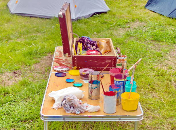 istock Cans of paint and brushes from an old suitcase on the table 1192471419