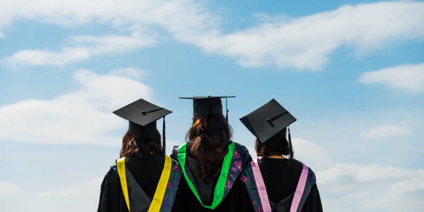 istock Rear view of three graduate students looking at sky 1192473955