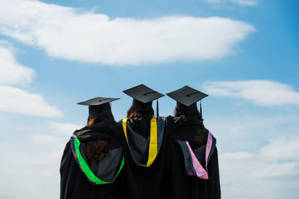 istock Rear view of three graduate students looking at sky 1192474012