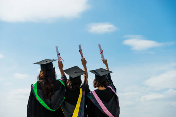 istock Three graduate students holding diplomas 1192474142