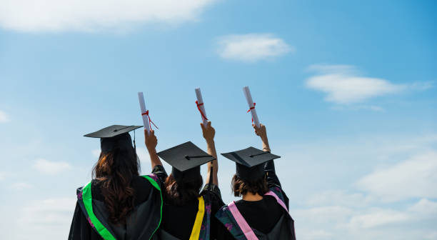istock Three graduate students holding diplomas 1192474374