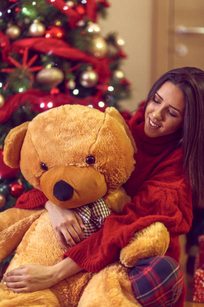 istock Happy woman and teddy bear Christmas Present 1192475015