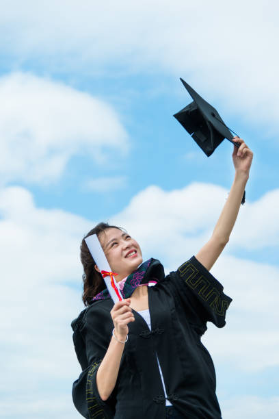 istock Happy female graduate with arms raised 1192475141