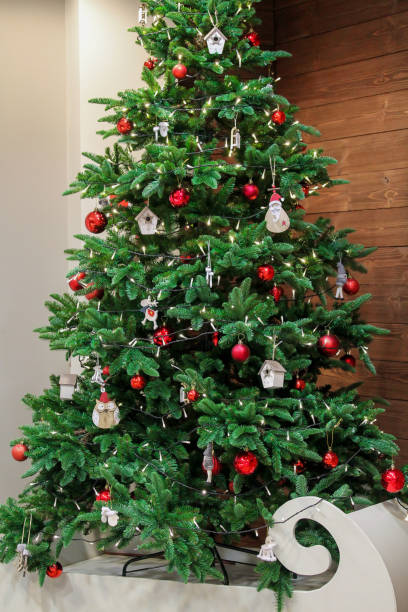 istock Christmas tree decorated with red shiny baubles and wooden figures 1192478259