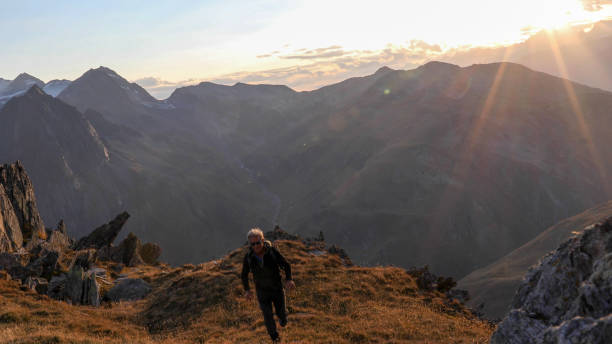 istock Hiker walks along mountain ridge at sunrise 1192479493