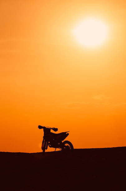 istock Silhouette of a motobike on sunset 1192479494
