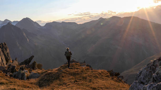 istock Hiker walks along mountain ridge at sunrise 1192479504
