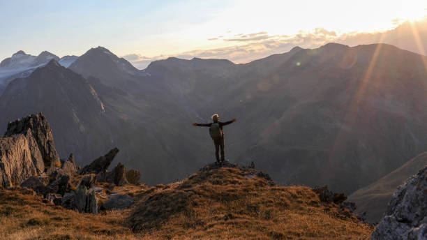 istock Hiker walks along mountain ridge at sunrise 1192479508