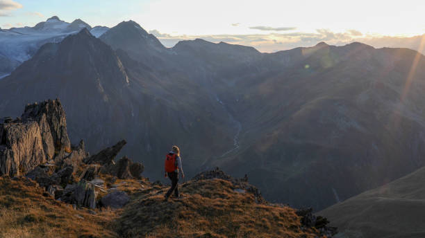 istock Female hiker walks along mountain ridge at sunrise 1192479796