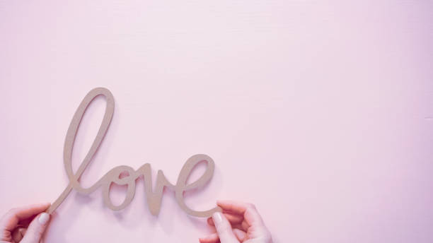 istock Valentine's Day LOVE sign on a pink background. 1192480114