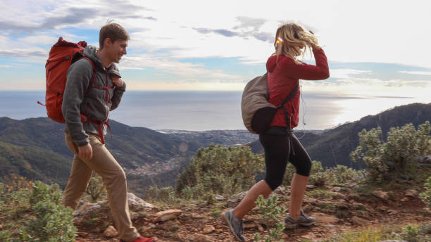 istock Siblings hike along footpath on mountain ridge 1192480172