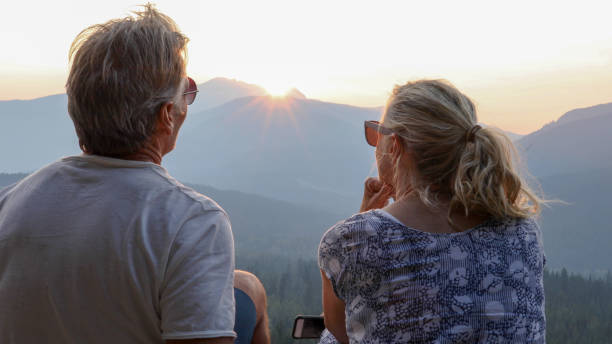 istock Mature couple relax on mountain ridge at sunrise 1192480201