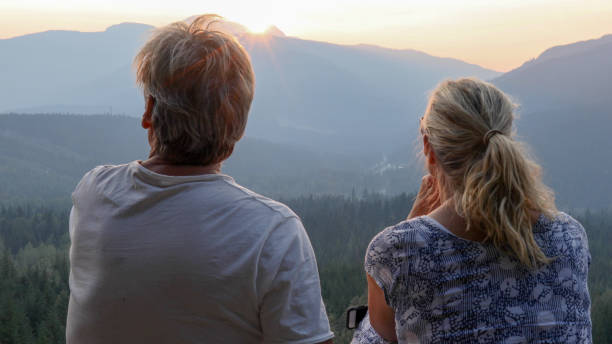 istock Mature couple relax on mountain ridge at sunrise 1192480785