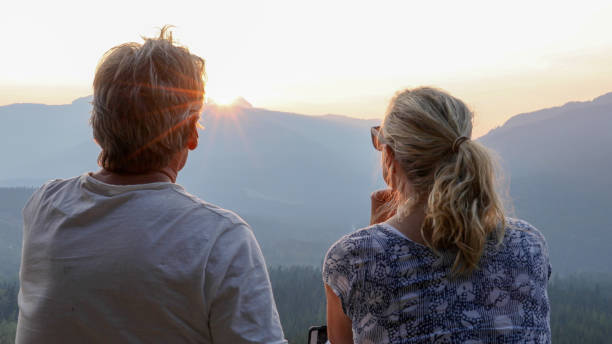 istock Mature couple relax on mountain ridge at sunrise 1192480922