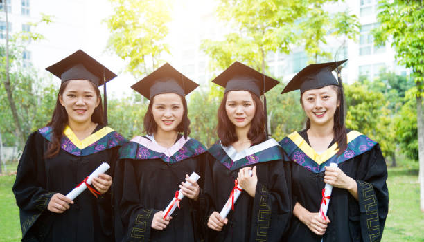 istock Four smiling graduates together on graduation day 1192481212