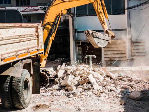 istock Bulldozer Removes the debris from demolition on the construction site 1192481360