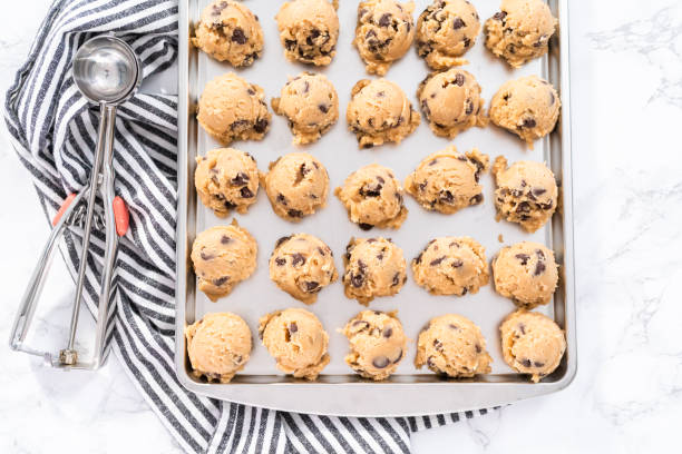 istock Homemade chocolate chip cookies dough scoops on a baking sheet. 1192481596