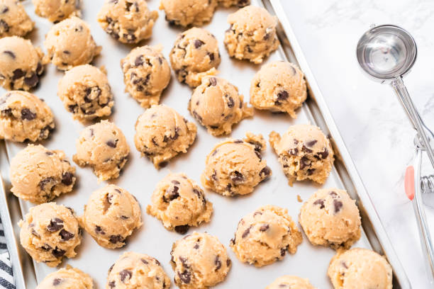istock Homemade chocolate chip cookies dough scoops on a baking sheet. 1192482844